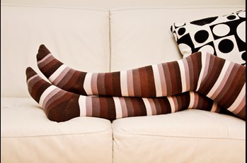 legs with socks resting on upholstery in Farmington Hills MI