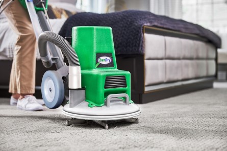 Technician cleaning carpet with Powerhead